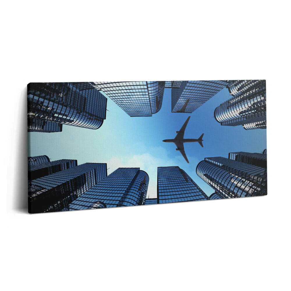 Imprimare tablou canvas 120x60 Avion deasupra clădirilor
