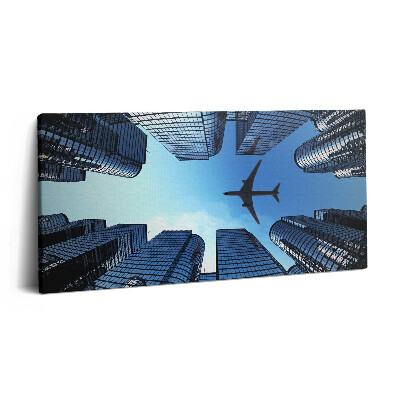 Print pe pânză 140x70 Avion deasupra clădirilor