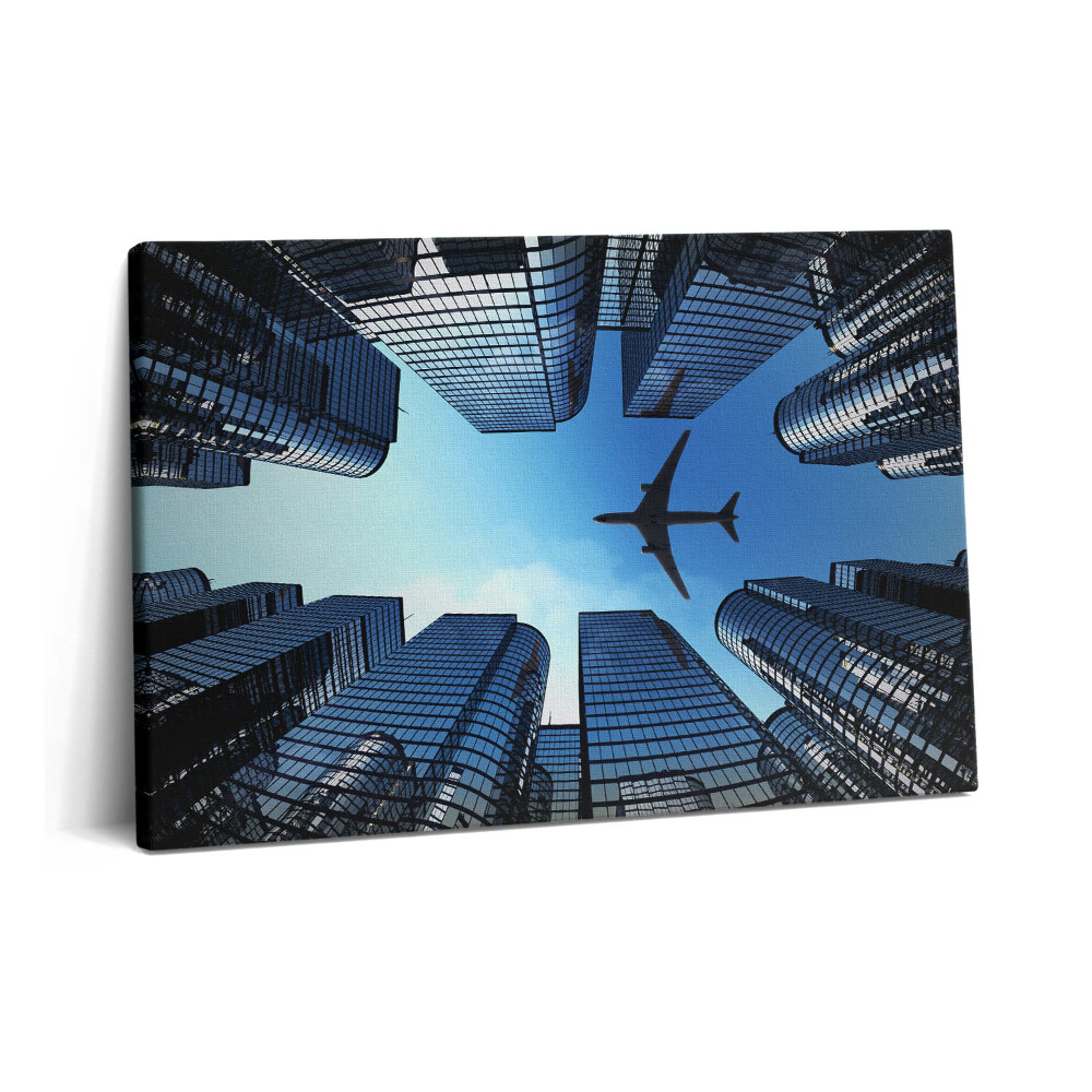 Tablou pe pânză 60x40 Avion deasupra clădirilor