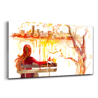 Tablou de sticlă Femeie pe bancă, peisaj de toamnă