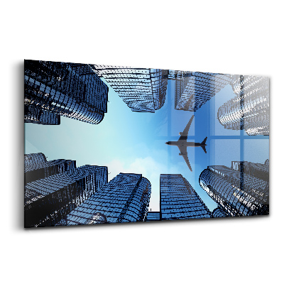 Tablou din sticlă Avion deasupra clădirilor
