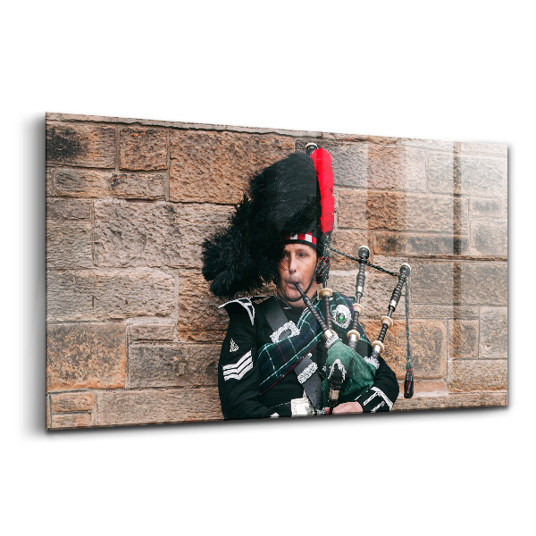 Tablou de sticlă Un muzician care cântă la cimpoi